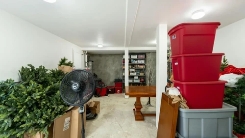 Holiday storage bins stacked in a basement